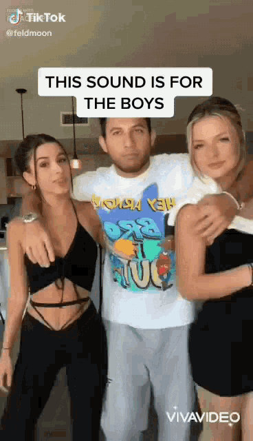 a man and two women are posing for a picture .