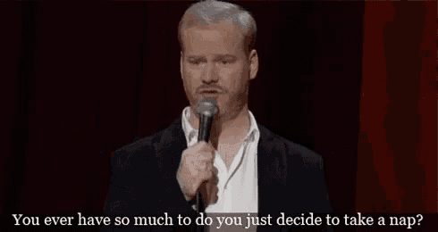 a man is speaking into a microphone on a stage .