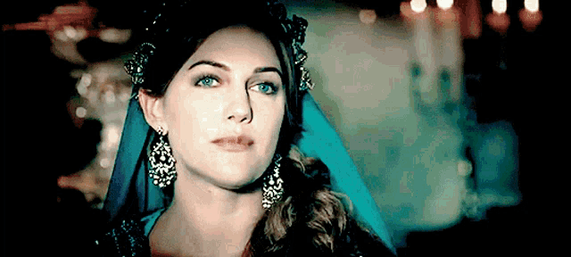 a close up of a woman wearing a blue dress