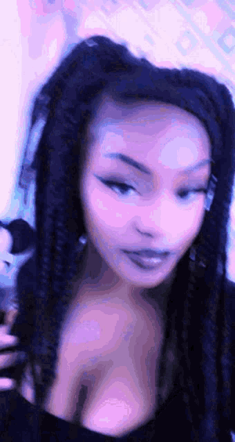 a close up of a woman 's face with purple hair