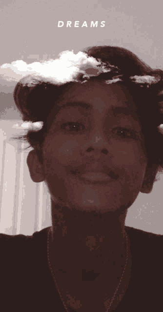 a young man with clouds on his head and the word dreams written above him