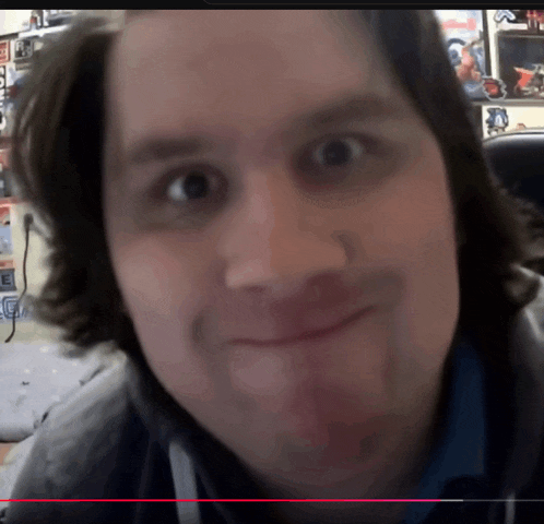 a close up of a man 's face with the letter e on the bottom right