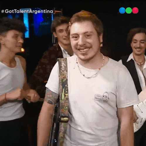 a man in a white t-shirt is smiling in front of a group of people with the hashtag #gottalentargentina on the bottom