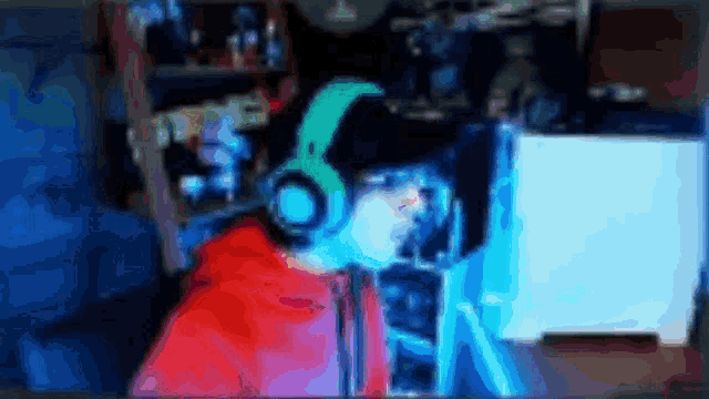 a person wearing headphones is sitting in front of a computer monitor