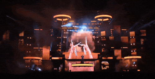 a stage with a lot of lights coming out of it and a person on it