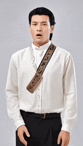 a man wearing a white shirt and black pants has a purse on his shoulder