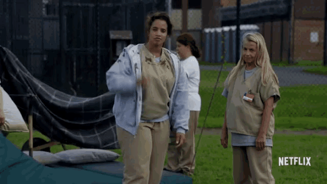 two women standing next to each other with a netflix logo in the corner