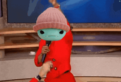 a person wearing a pink beanie and a red coat is holding a microphone