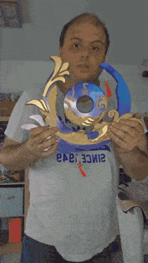 a man in a white adidas shirt is holding a blue and gold item