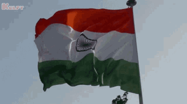 a red white and green flag is waving in the wind with the word kulpy in the upper right corner