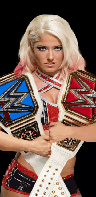 a female wrestler holds a blue and red championship belt