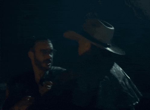 a man is carrying another man in the rain