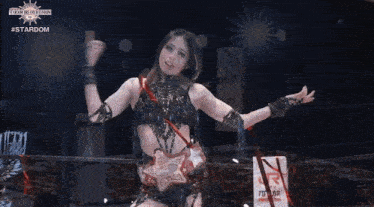 a woman in a black dress is standing in front of a screen that says stardom