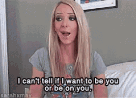 a blonde woman is sitting on a bed with a surprised look on her face .