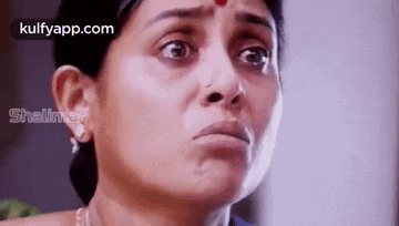 a close up of a woman 's face with tears running down her face .