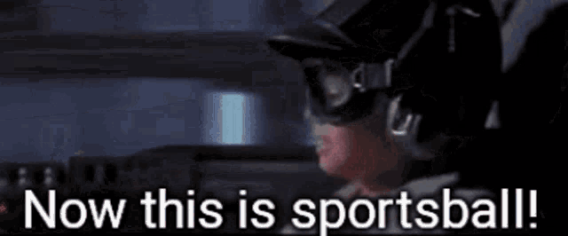 a man wearing a helmet and goggles is holding a gun and says now this is sportsball .