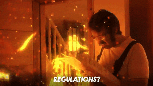 a man is reading a book in front of a fire with the words " regulations " written on the bottom