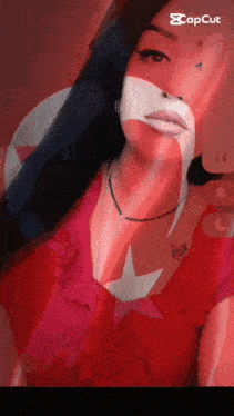 a woman in a red top is taking a selfie with a capcut watermark