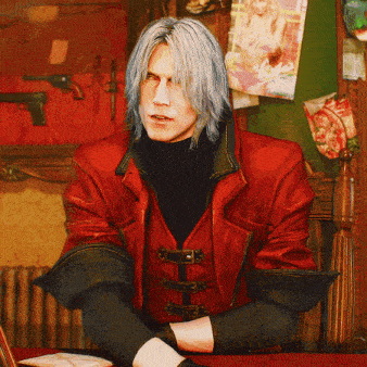 a man in a red leather jacket sits at a desk