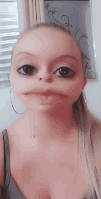 a woman making a funny face with her eyes closed