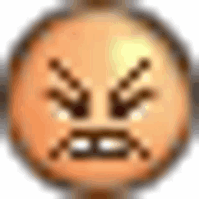 a close up of an angry smiley face with a blurred background