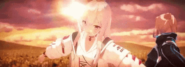 a man and a girl are holding hands in a field at sunset .
