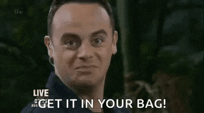 a man is making a funny face and saying `` get it in your bag '' .