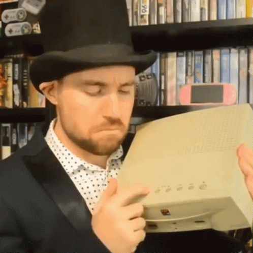 Press Buttons Top Hat Gaming Man GIF - Press Buttons Top Hat Gaming Man Pressing The Buttons On The Console GIFs