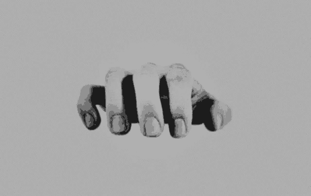 a black and white photo of a person 's hands on a gray background .