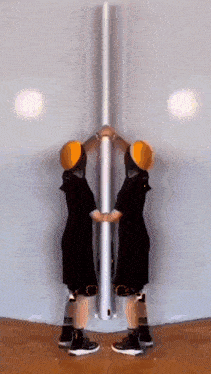 a person standing in front of a mirror with a yellow hat