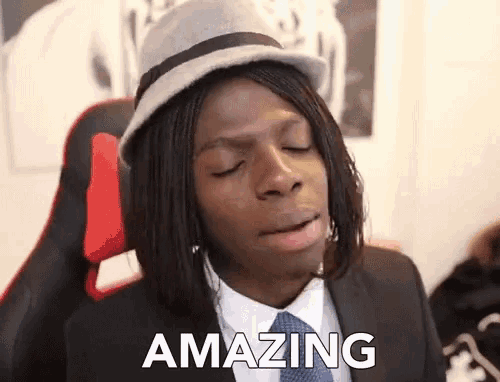 a man wearing a hat and a suit says " amazing "