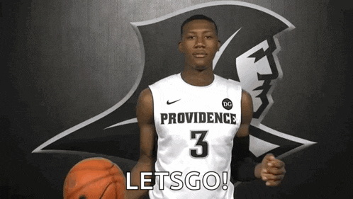 a man in a providence jersey holds a basketball and says let 's go