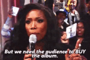 a woman singing into a microphone with the words but we need the audience to buy the album
