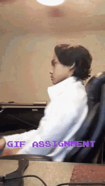 a man is sitting in a chair with the words gif assignment written above him