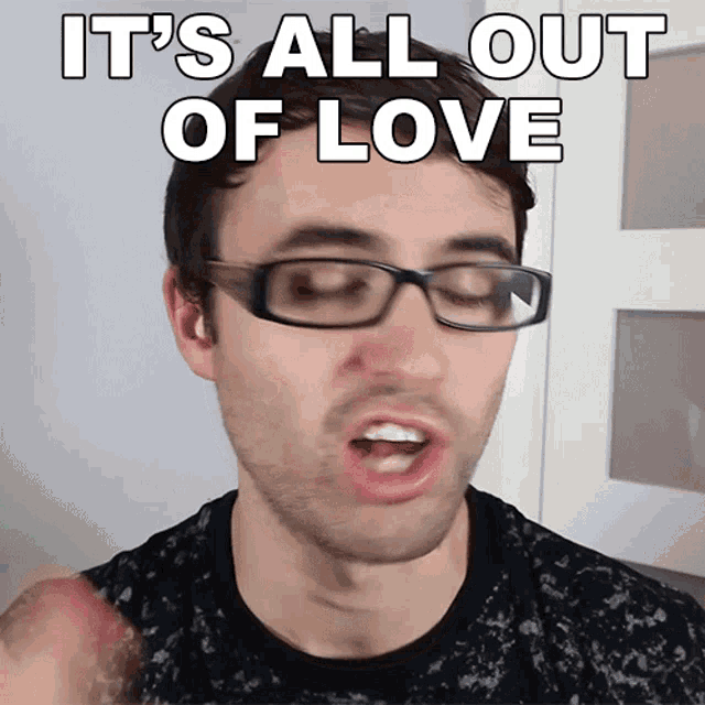 a man with glasses says it 's all out of love with his mouth open