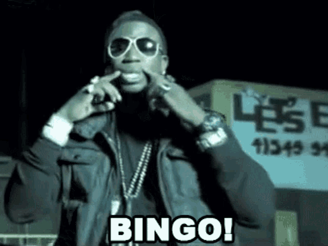 a man wearing sunglasses and a leather jacket says " bingo "