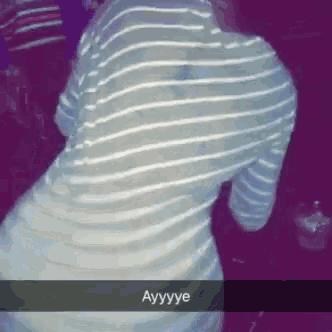 a woman in a striped shirt is dancing with the word ayyyye written on the bottom