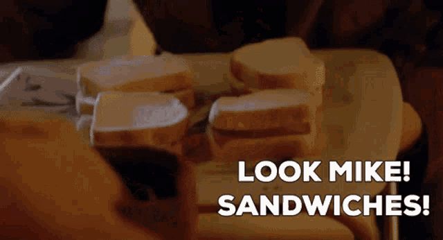 a tray of sandwiches with the words look mike sandwiches written on it