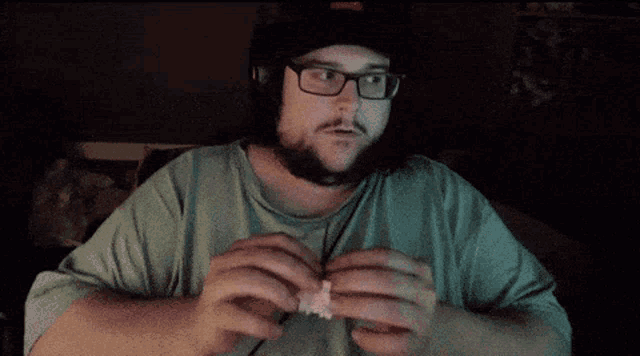 a man with a beard wearing glasses and a hat