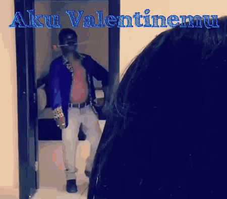 a man is standing in a doorway with aku valentinemu written on it