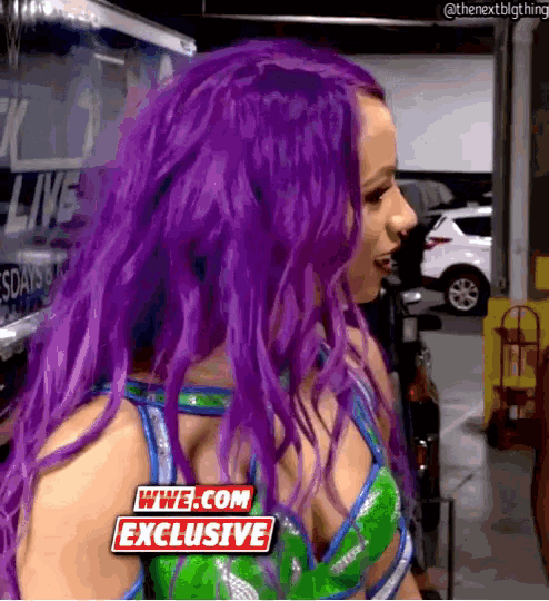 a woman with purple hair and a wwe.com exclusive sticker