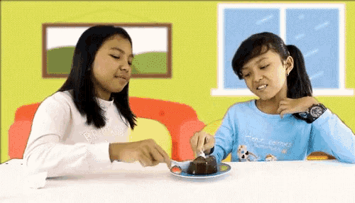 a girl wearing a brooklyn shirt sits at a table with another girl