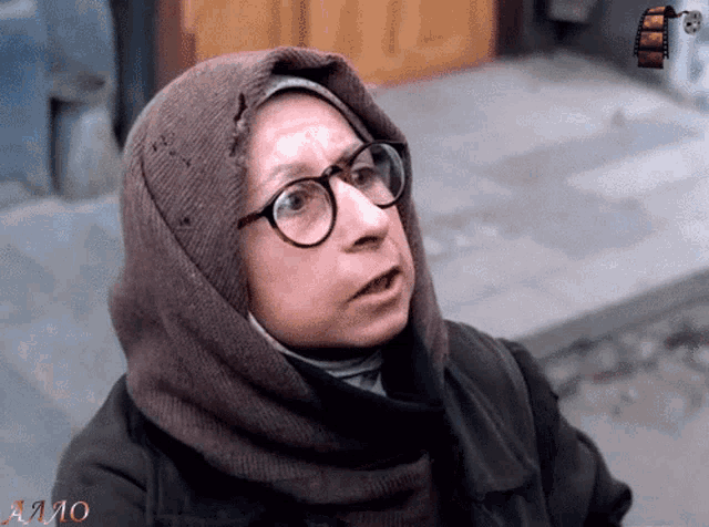 a woman wearing glasses and a scarf has the word amo on the bottom