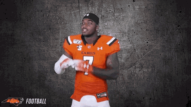 a football player wearing a jersey that says camels on it