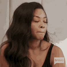a woman is wearing a black bra and a bravo logo on her arm