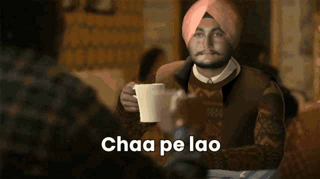 a man in a turban sits at a table with a cup of coffee and the words chaa pe lao below him