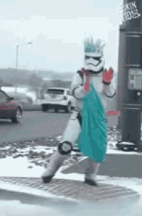 a storm trooper holding a blue cloth in front of a dunkin donuts building