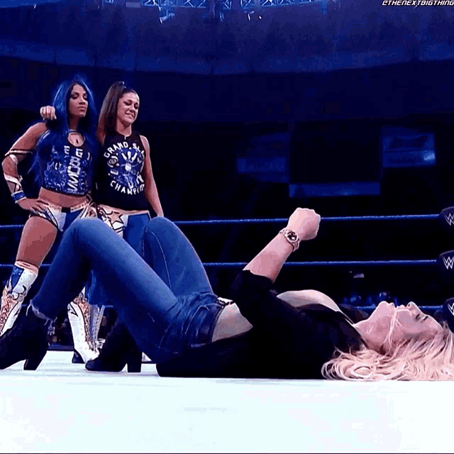 a woman laying on the ground with a shirt that says grand slam champion