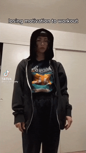 a woman wearing a hoodie and a t-shirt that says ' losing motivation to workout '