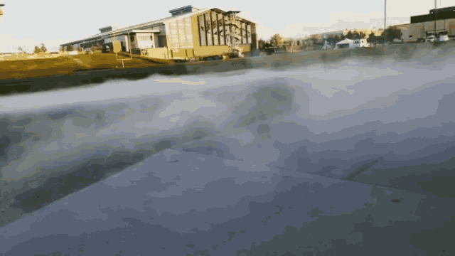 smoke coming out of a concrete surface in front of a building that says ' abercrombie & fitch ' on it